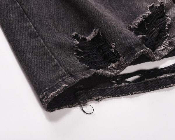 Image of a Custom Denim Jacket with washed hole whisker design